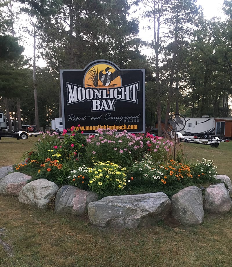 Moonlight Bay Sign in front of flowers
