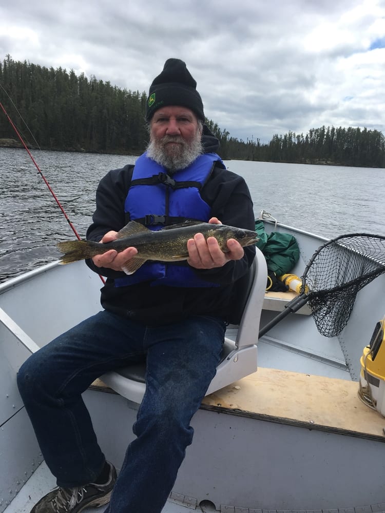 Hargrave on boat holding a walleye