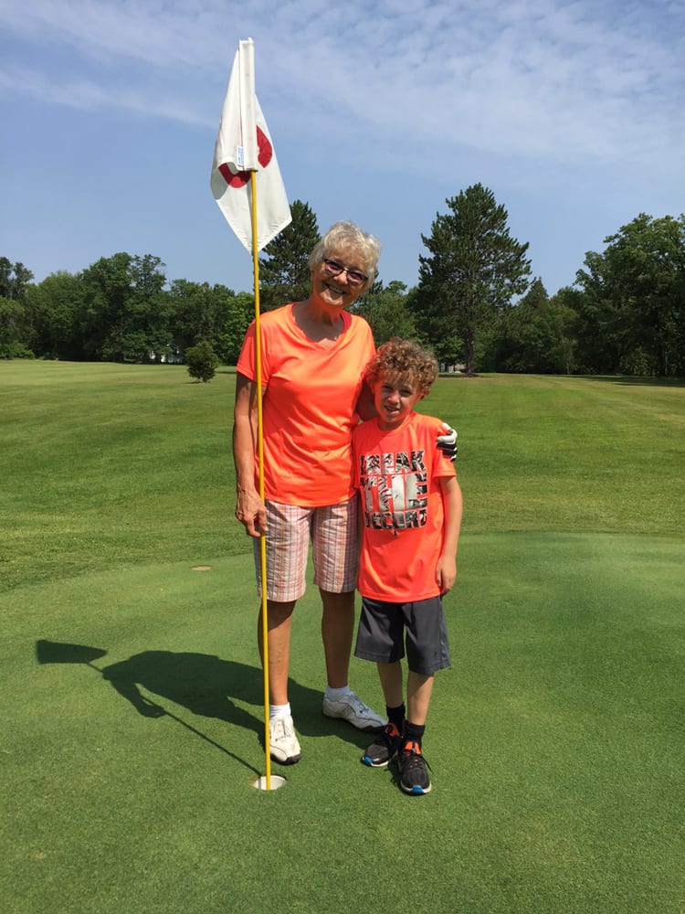 Mother and son at golf hole.