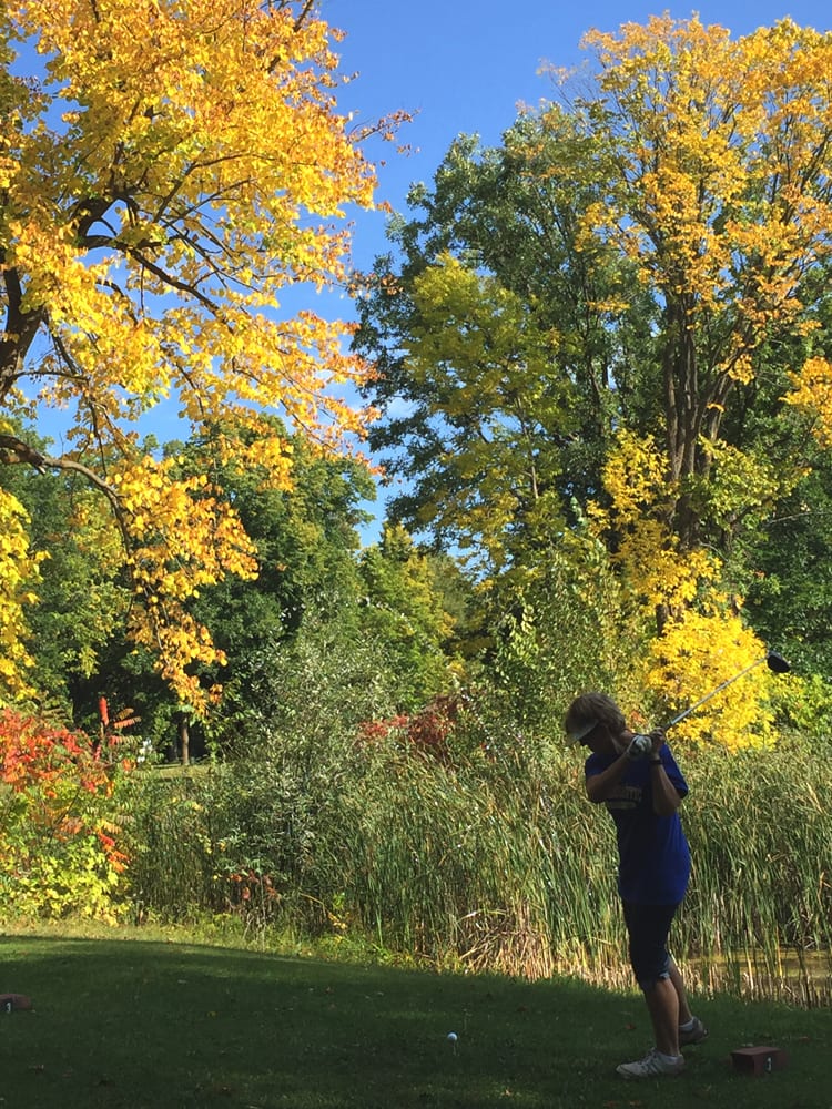 Golfer on backswing in autumn
